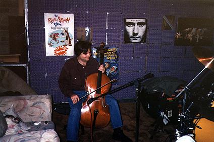 Al playing cello in our garage/studio at the party.  Notice the Stimpy and Genesis posters.